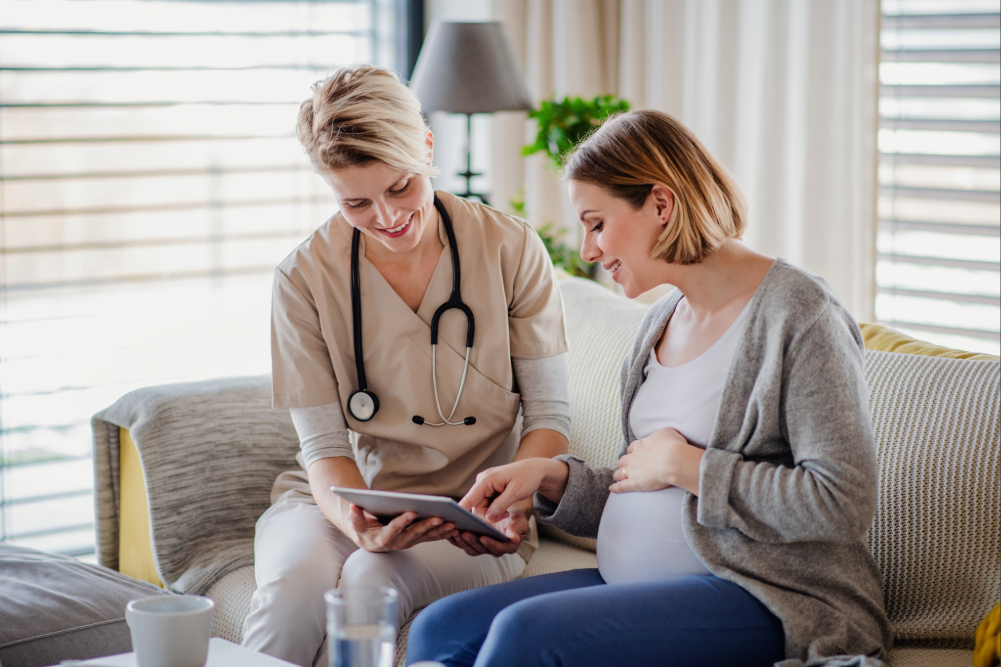Woman speaking with Nurse.